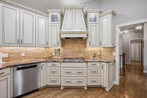 A decorative range hood creates an attractive focal point above the gas cooktop.