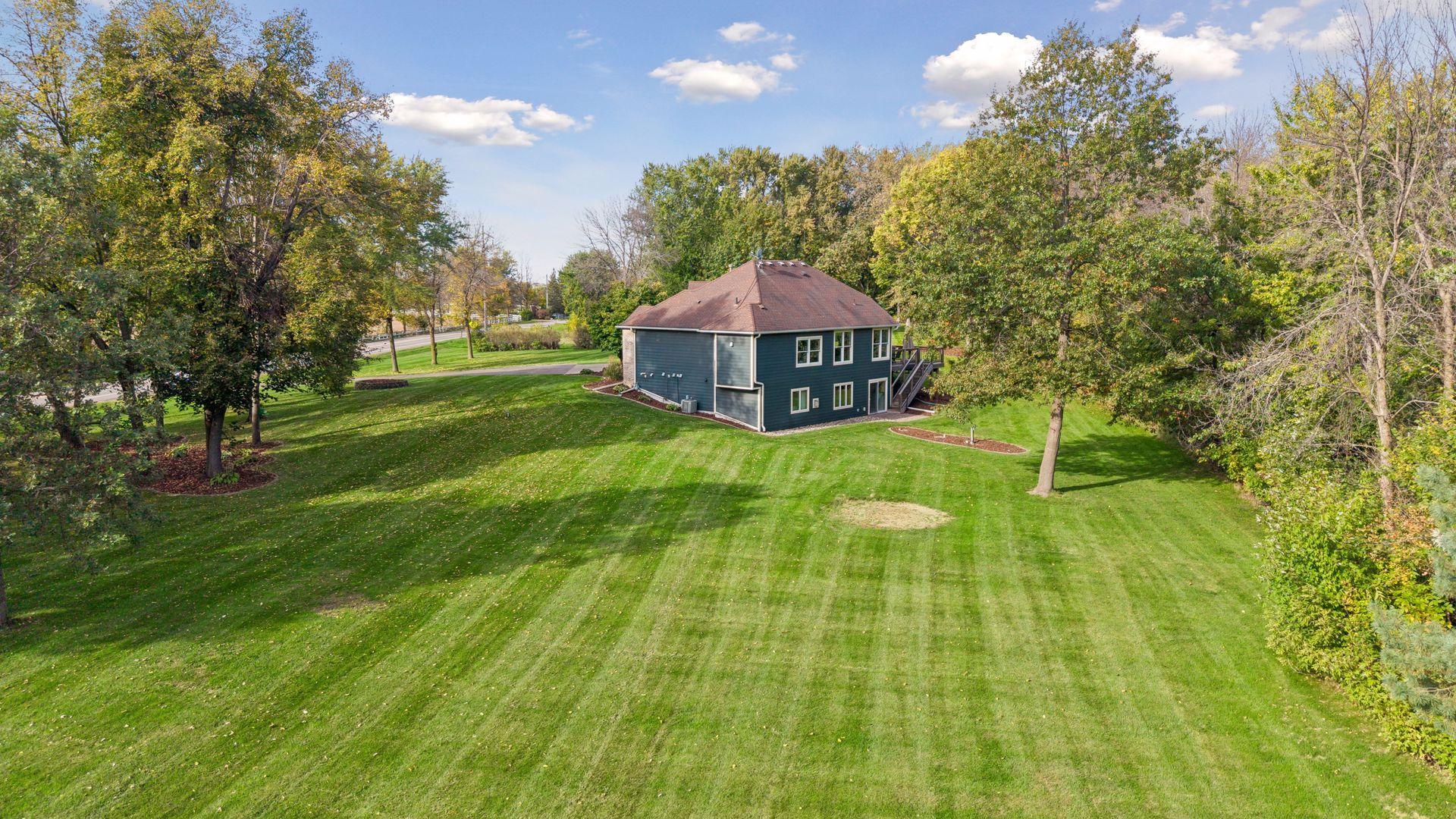 The expansive backyard offers abundant green space for outdoor activities, gardening, and quiet enjoyment.