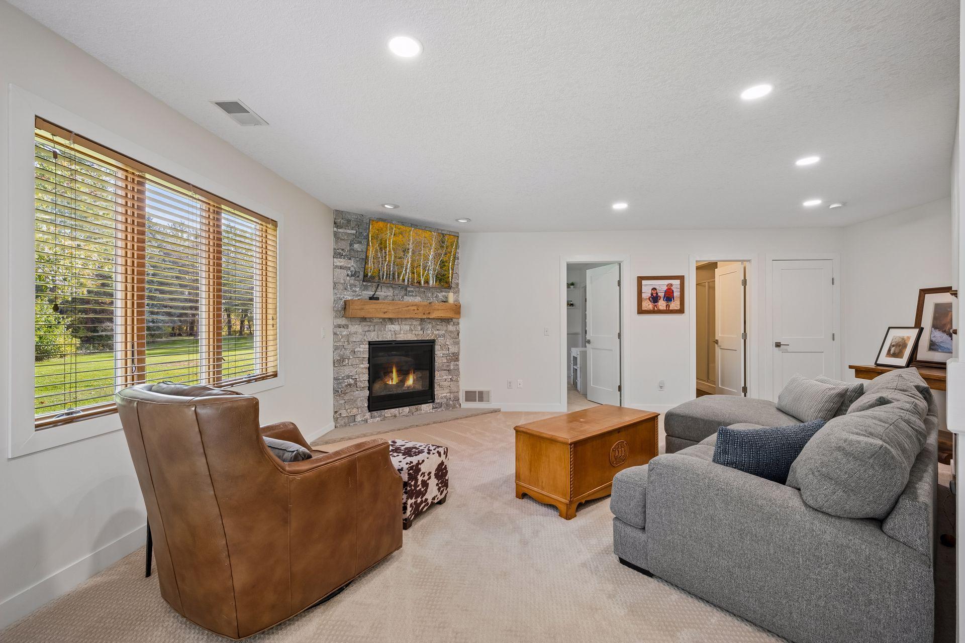 The lower-level family room offers a cozy, warm, and relaxed setting for movie nights and casual entertaining.