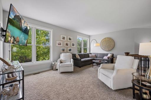 Multiple windows bring the outdoors in and enhance the living roomâs bright, airy atmosphere.