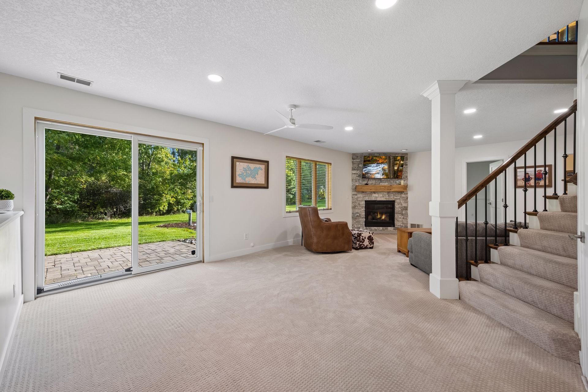 The walkout lower level opens to a comfortable family room with recessed lighting and a gas fireplace. A sliding glass door fills the lower level with natural light and provides direct backyard access.