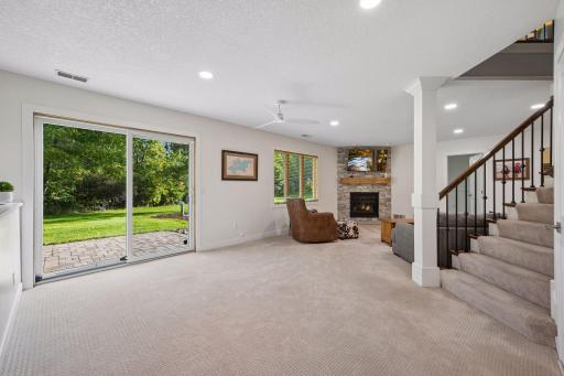 The walkout lower level opens to a comfortable family room with recessed lighting and a gas fireplace. A sliding glass door fills the lower level with natural light and provides direct backyard access.