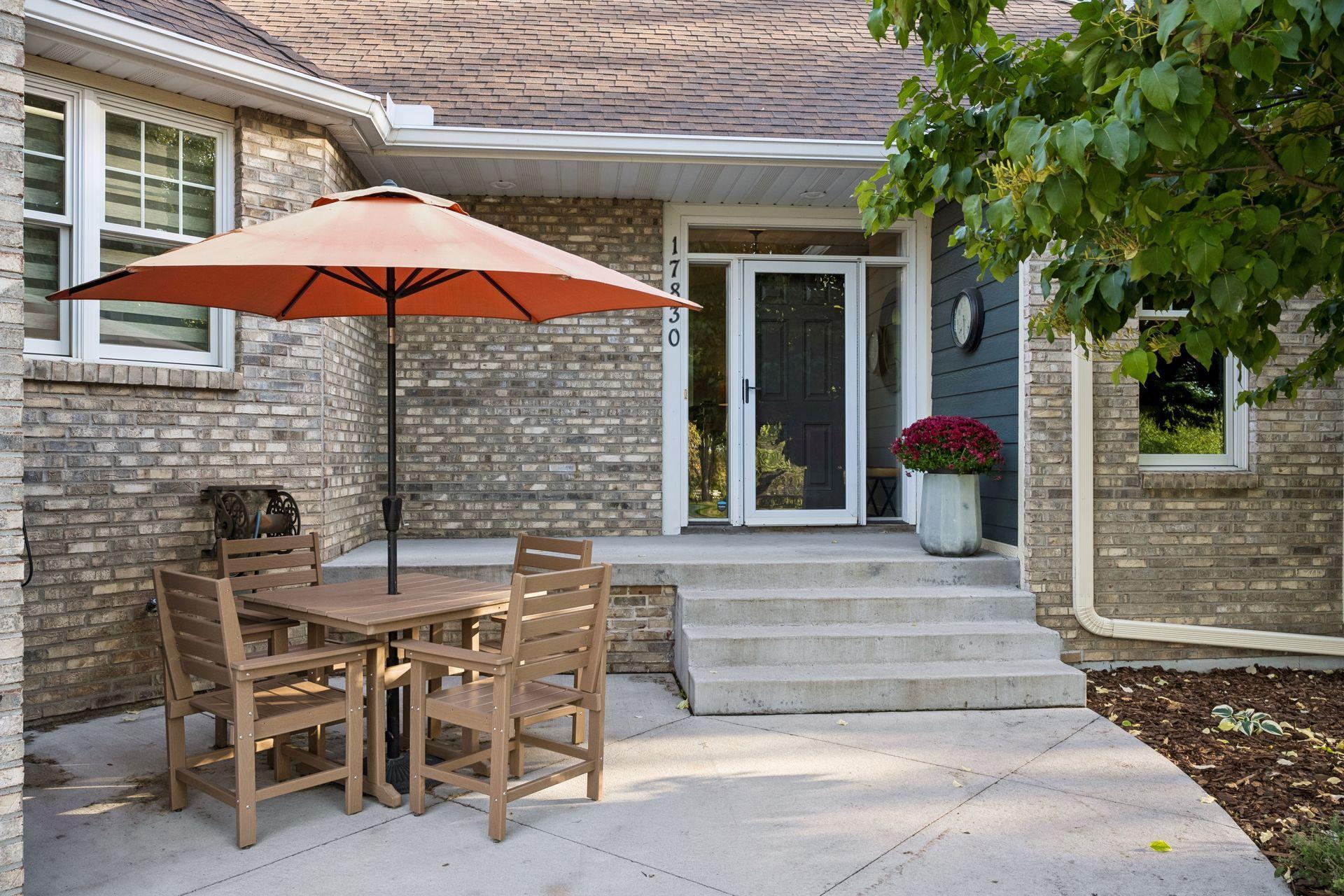 This front patio creates a charming spot for morning coffee, outdoor dining, or conversation.