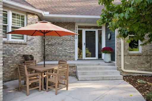 This front patio creates a charming spot for morning coffee, outdoor dining, or conversation.