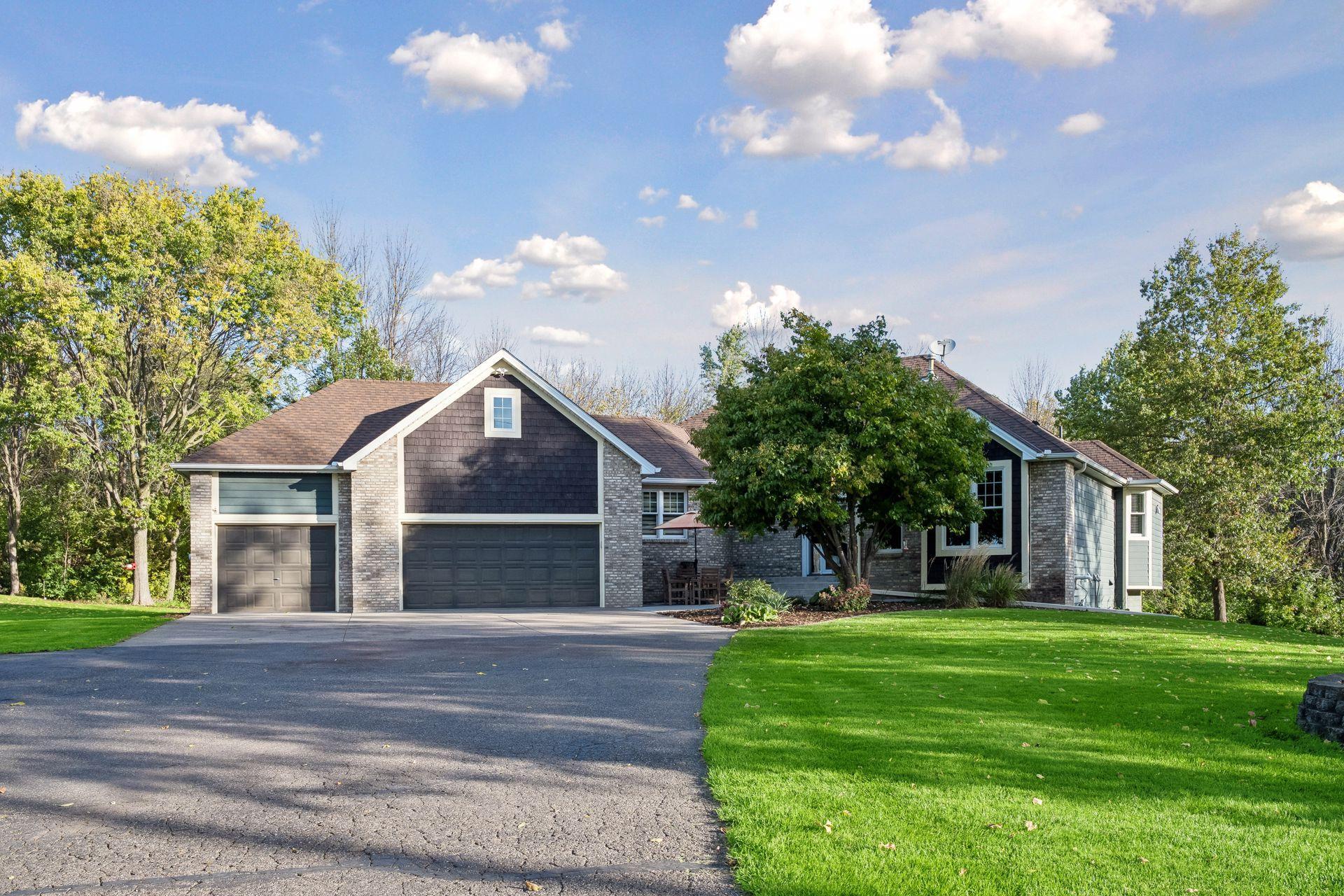 An inviting exterior with an attached three-car garage and plenty of driveway space for guests.