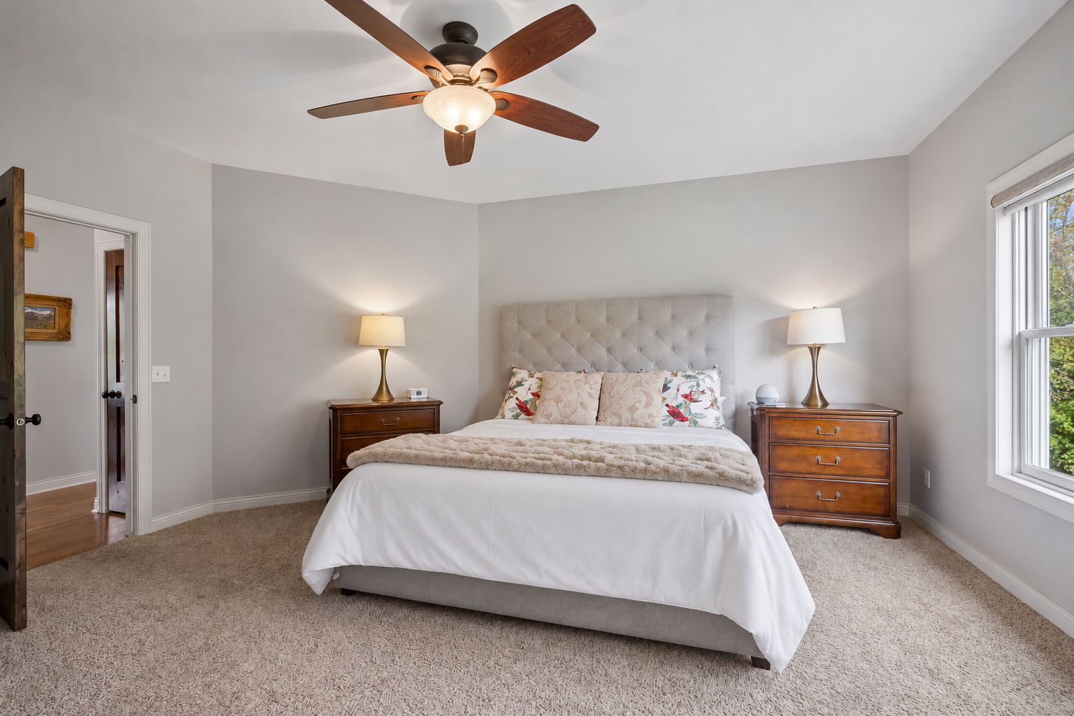 The primary suite features abundant natural light, knotty alder doors, a private bath, and a spacious walk-in closet.