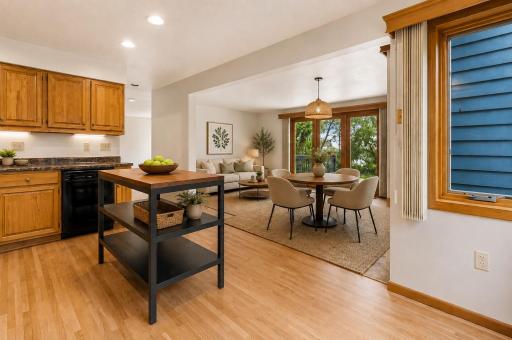 This photo is virtually staged showing the kitchen that opens into the sitting area or formal dining area.