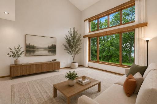 This virtually staged living room area shows how grand this room really is. It has so much natural light, a great view and room to entertain!