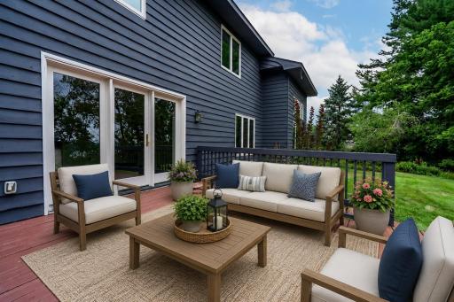 A very large deck overlooks the amazing backyard with scenic lake views! This virtually staged deck decor is just an idea of how to style it once you move in!
