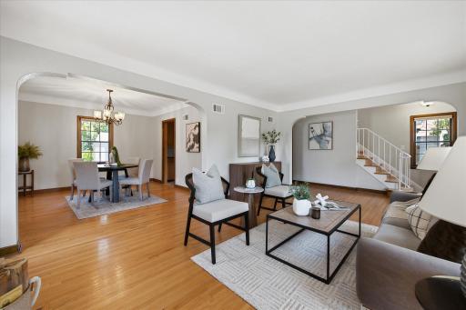 The spacious main level offers an easy flow between the living and dining areas, with beautiful hardwood floors, arched openings, and abundant natural light throughout.