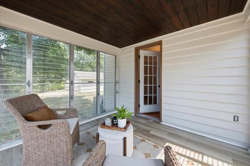 Surrounded by windows, the three-season porch brings in abundant natural light and offers a comfortable extension of the living space with views of the surrounding neighborhood.