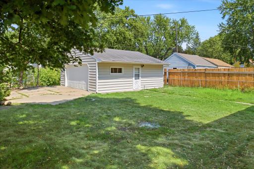 The spacious backyard offers plenty of room for outdoor gatherings, lawn games, and relaxing with family and friends, with convenient access to the detached garage for parking, storage, and outdoor activities.
