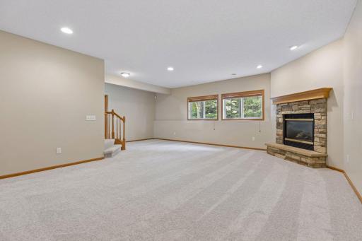 Lower level family room with fireplace & lookout windows