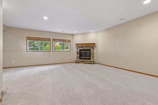 Lower level family room with fireplace & lookout windows