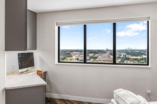 Kitchen workspace positioned beside a large window showcasing panoramic views from the 29th floor.
