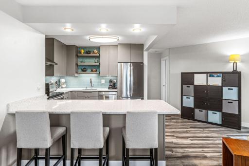 Spacious kitchen peninsula offers casual seating, generous prep space, and a natural gathering place for entertaining.