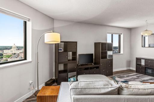 Living room window captures a sweeping 29th-floor outlook over the city and surrounding skyline.