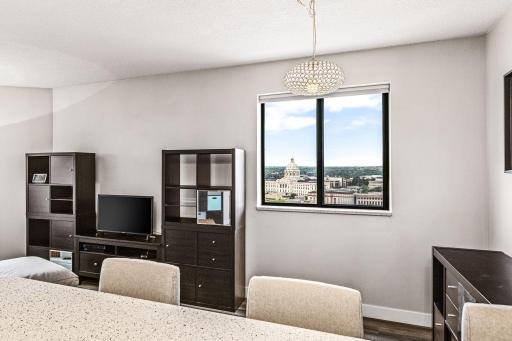 Light-filled dining area featuring two large windows and elevated views from this end-unit condominium.
