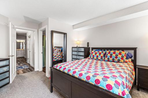 Primary bedroom offers a comfortable layout, neutral finishes, and convenient access to the adjoining hallway.