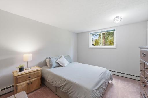 Lower-level bedroom showing its spacious layout and natural light.