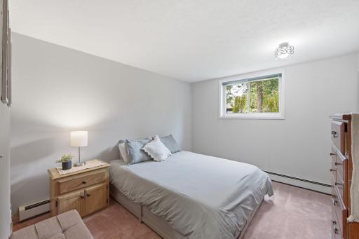 Comfortable lower-level bedroom with natural light and ample space for furnishings.
