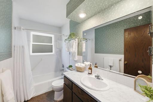 Main floor full bath with window to allow for natural light.