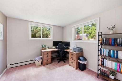 Versatile lower-level room with two windows, closet and space well suited for a home office or additional flex space.