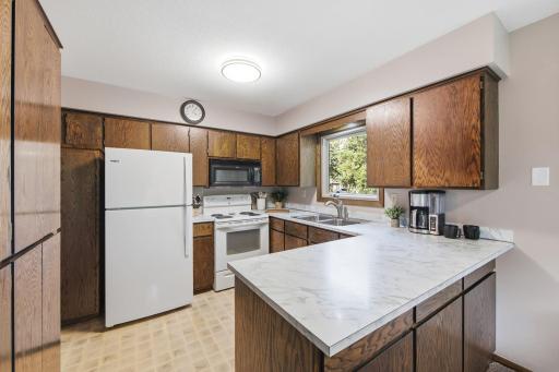 Additional kitchen view highlighting the peninsula, counter space and cabinetry.
