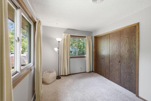Additional view highlighting the bedroom’s double windows and large closet.