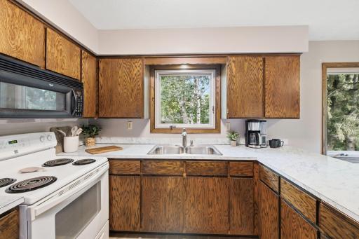 Kitchen window brings in natural light while generous work surfaces provide plenty of room for meal preparation.
