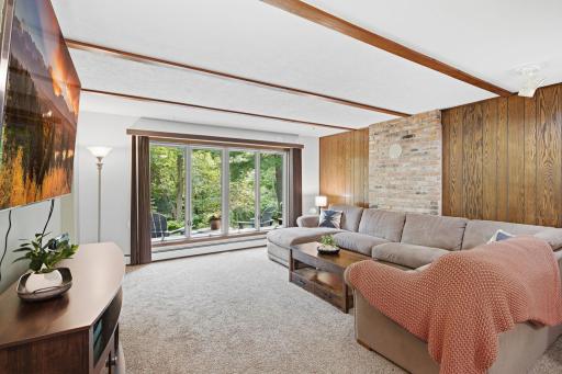 Spacious finished family room provides a second gathering area with large windows and natural light.