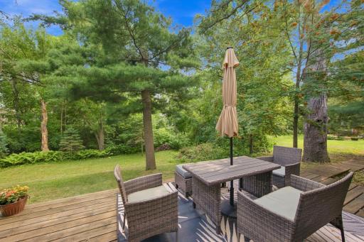 Enjoy outdoor living surrounded by the mature trees and natural beauty of the backyard.