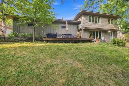 Rear exterior view showcasing the expansive deck and backyard setting.