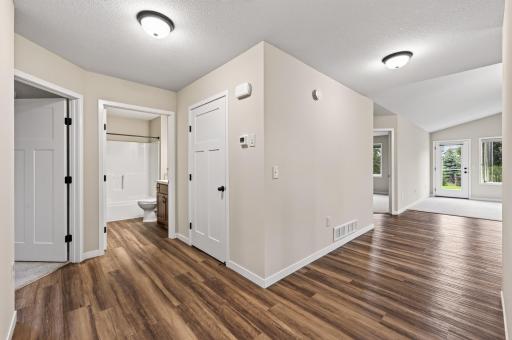 Welcoming entry with durable large plank luxury vinyl plank flooring.