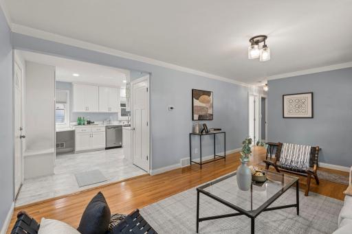Another perspective of the living room showcasing the nearby updated kitchen.