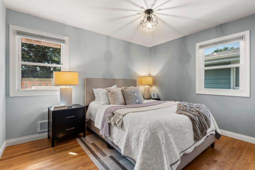 Two main floor bedrooms feature original wood floors and ample closet space.