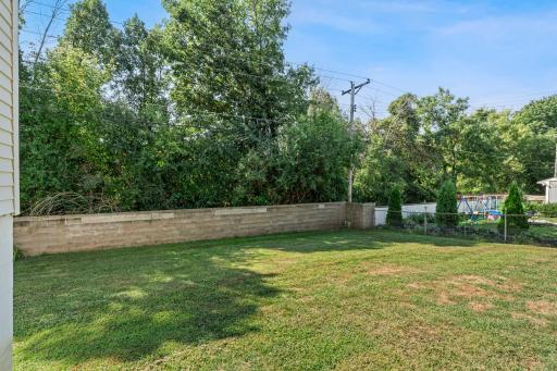 The spacious fenced backyard, offering plenty of room to relax, play, and entertain.