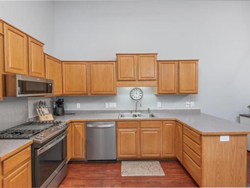Kitchen area with newer dishwasher, microwave and gas cooking stove.