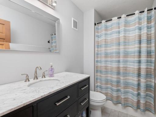 Owners bath with tall vanity and shower here is oversized.