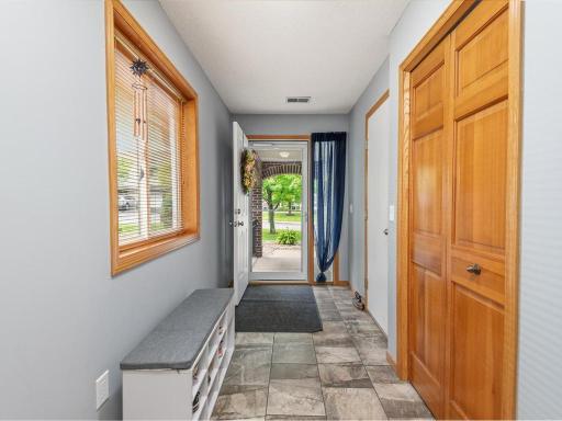 Spacious foyer with coat closet and entry to garage area.
