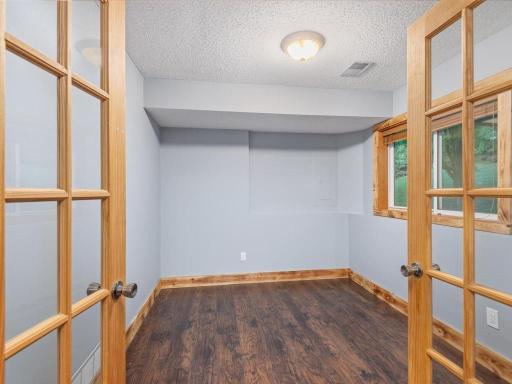 Small lower level bedroom or office. No closet but there is an attached shelving unit for clothes hanging, etc.