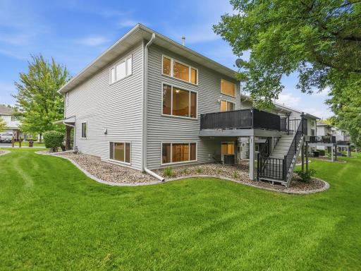 Back of home. Great lawn space and deck has stairs to access the yard.