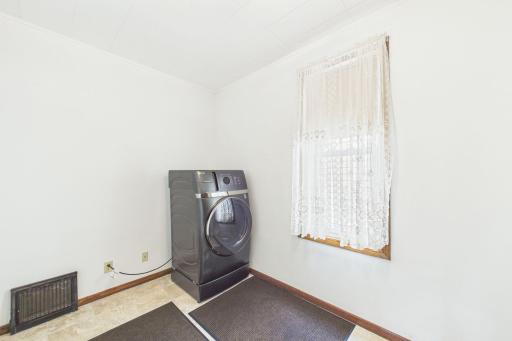 Main level laundry with combined washer/dryer! Large room with closet too! Note there is additional washer and dryer in the basement!
