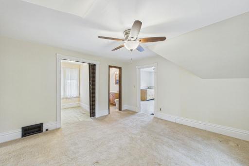 Angle from upper large room with view of smaller room, bathroom, and kitchen.
