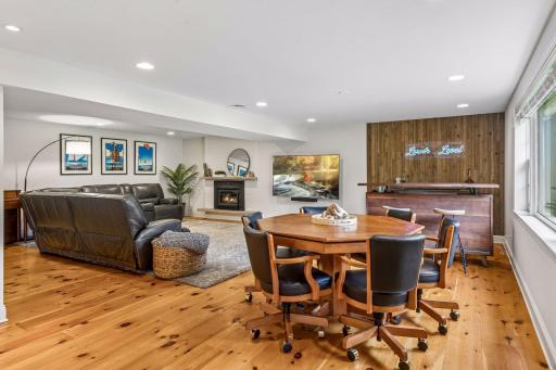 Spacious lower level walkout with a gas fireplace and hardwood floors.