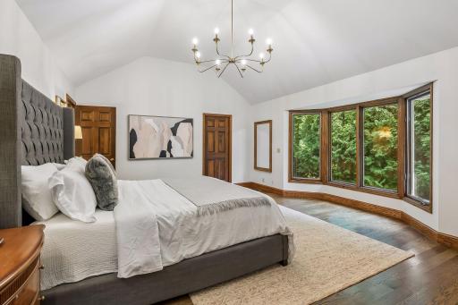 A peaceful place to begin and end the day, with vaulted ceilings, warm hardwood floors and a generous bay window that brings the surrounding greenery into view