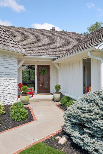A welcoming approach framed by mature landscaping leads to an inviting entry where thoughtful details begin to set the tone for the home.