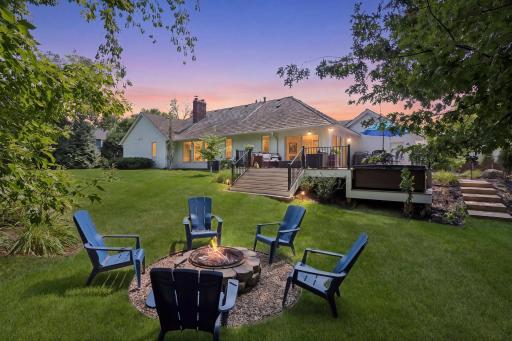 As evening settles in, the backyard becomes a place to linger, with the firepit creating a natural gathering spot and the deck and hot tub waiting just beyond for the evening to continue.