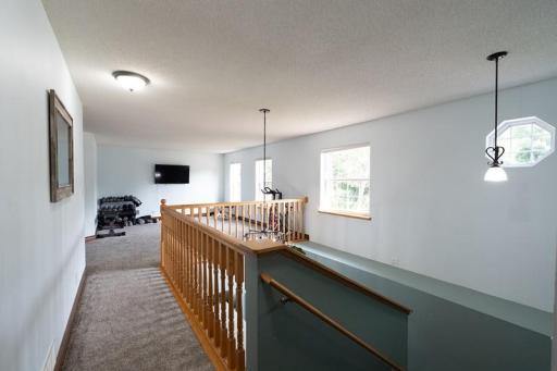 Upstairs loft area with a beautiful open staircase