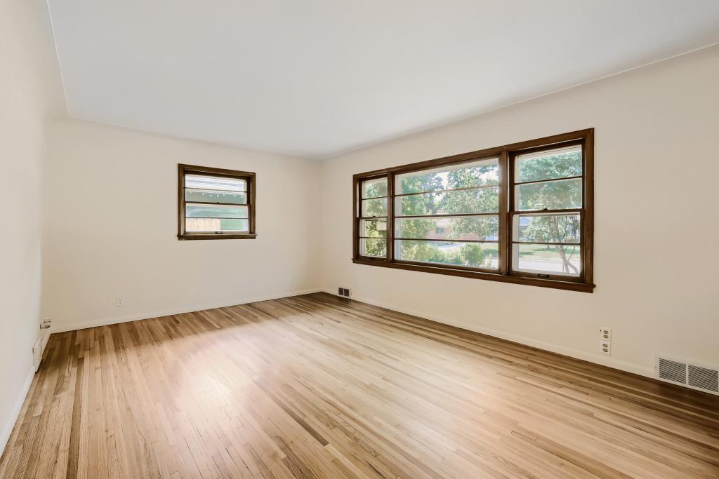 Main floor living room with gorgeous real wood floors and abundant natural light.